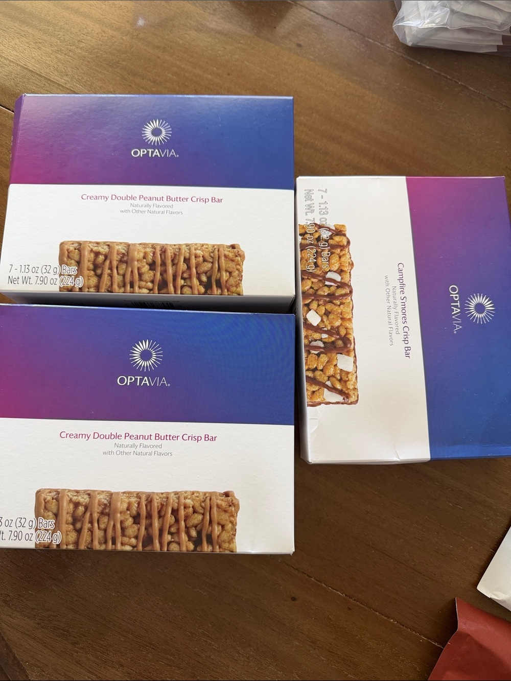 OPTAVIA 2 Creamy Double Peanut Butter Crisp Bars, 1 Campfire S’mores Crisp bars.